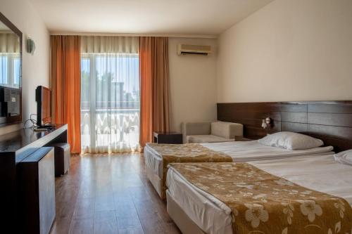 A bed or beds in a room at Asteria Family Sunny Beach - Ultra All Inclusive
