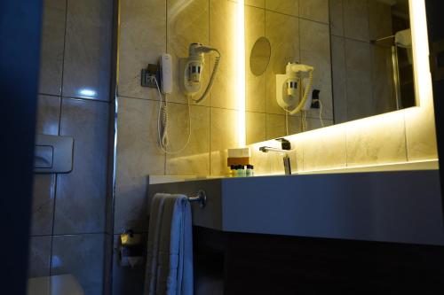 a bathroom with a sink and a phone on the wall at Hotel Kırcı Termal & Spa in Bursa