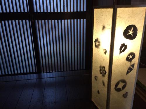 a light in a room with footprints on the wall at Secret Garden Kyoto in Kyoto