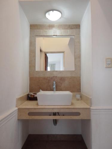 a bathroom with a sink and a mirror at LA CASA Nostra in Valle Hermoso