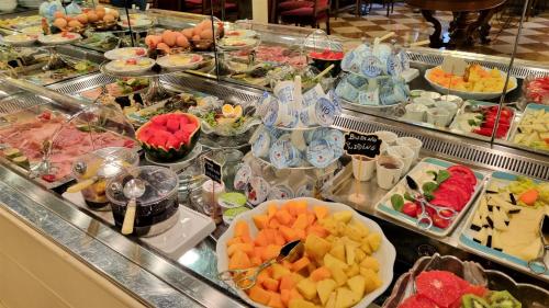a buffet filled with lots of different types of food at Art Hotel Orologio in Bologna