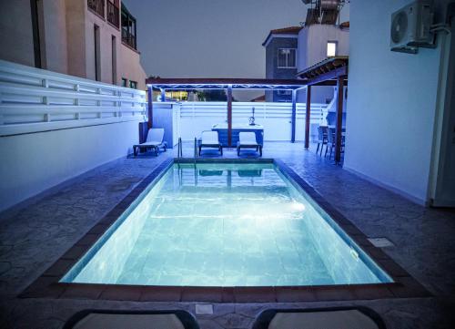 a swimming pool in the middle of a building at Nissi Villa Sotia in Ayia Napa