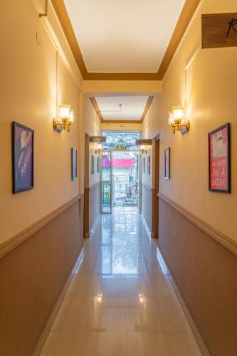 an empty hallway in a building with lights on the walls at Whoopers Hostel Bir in Bīr
