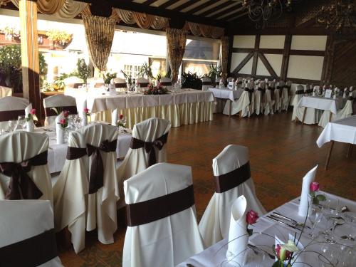 a banquet hall with white tables and chairs at Hotel Zum weißen Stein in Kirchen