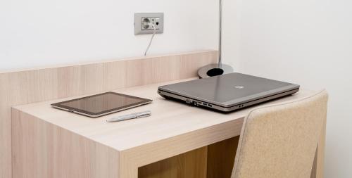 a laptop computer sitting on top of a desk at Hotel Armatti in Braşov