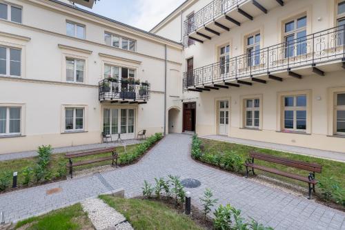 two benches in front of a building at Apartament w centrum Krakowa 109 in Kraków