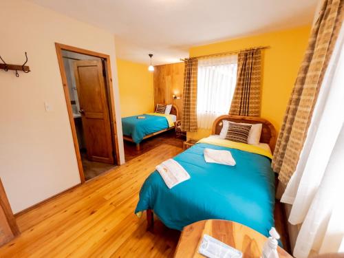 a bedroom with two beds in a room at Hotel y Spa Isla de Baños in Baños