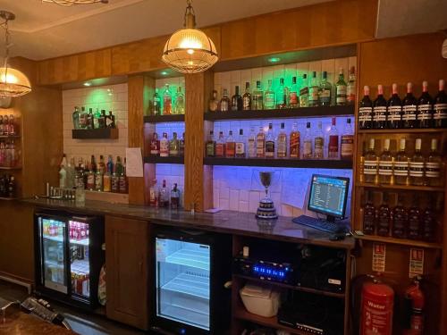a bar with a lot of bottles on the wall at The Grey Horse in Darlington