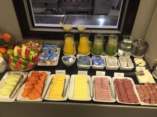 a display case with many different types of food at Blue Hill Hotel in Timbó