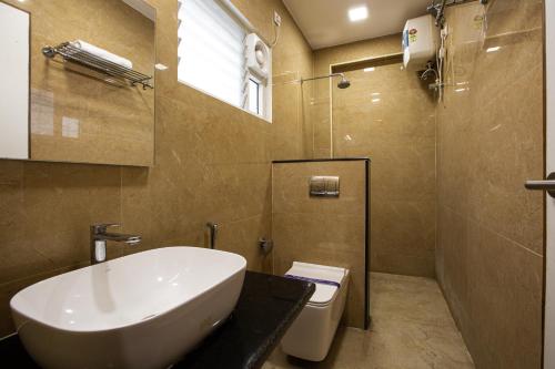 a bathroom with a sink and a toilet at Santhoshpuri in Coimbatore