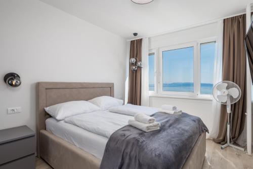 a bedroom with a bed with two towels on it at Heaven View Apartment in Rijeka