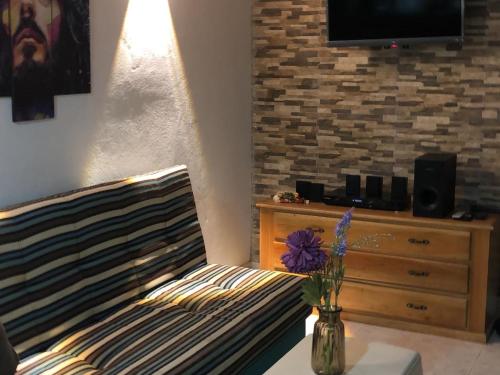 a bedroom with a bed and a dresser with a tv at Jamadis in Tolú