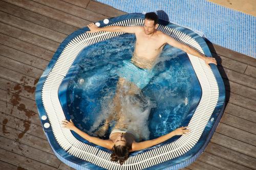 a man and a woman in a swimming pool at JS Paradise Sport - Adults Only in El Arenal