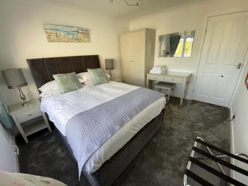 a bedroom with a large bed and two night stands at Beau Vallon Holiday Apartments in St Pierre du Bois