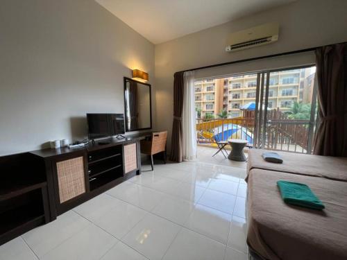 a hotel room with a bed and a balcony at Relax At Gold Coast Morib in Banting