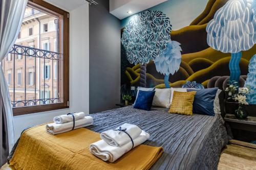 a bedroom with a large bed with towels on it at Ugo Bassi Apartments in Bologna