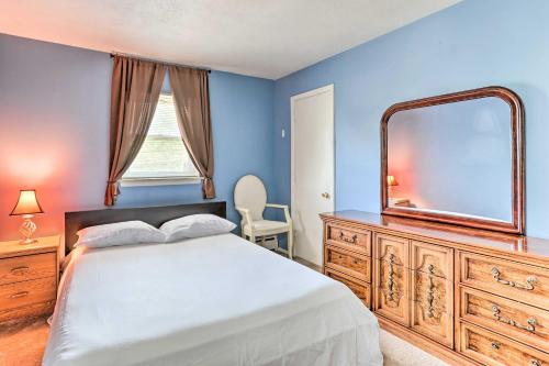 a bedroom with a bed and a mirror and a dresser at Family-Friendly Allentown Abode with Backyard! in Allentown