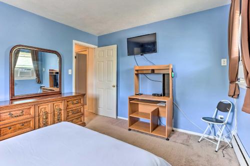 a bedroom with a bed and a mirror and a dresser at Family-Friendly Allentown Abode with Backyard! in Allentown