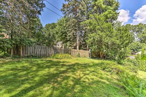a yard with a wooden fence and a grass field at Family-Friendly Allentown Abode with Backyard! in Allentown