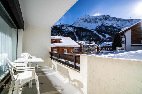 a balcony with a view of a snowy mountain at Haus Camillo in Saas-Fee