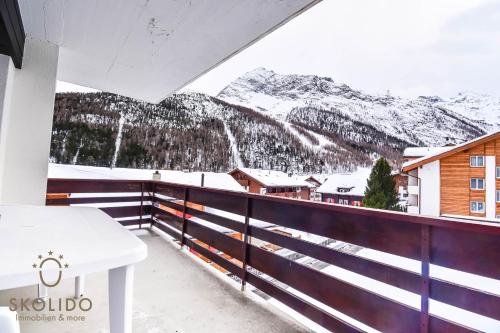 a balcony with a view of a snow covered mountain at Haus Camillo in Saas-Fee