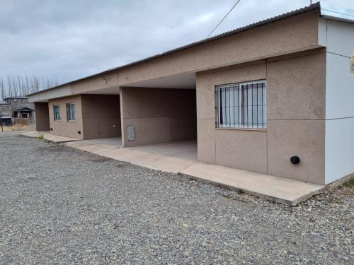 a building with three parking spaces in front of it at FAMILY HOUSE MALARGUE in Malargüe