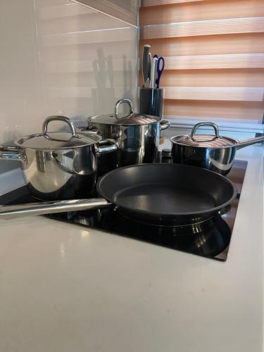a group of pots and pans on a stove in a kitchen at Homestay Shah Alam in Shah Alam