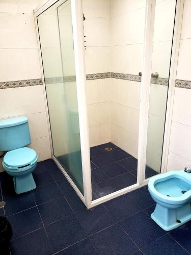 a bathroom with a shower and a toilet at Singular Coyoacán Pepper My Love! in Mexico City
