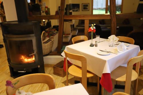 a table in a restaurant with a fireplace at Hotel Andino Club - Hotel Asociado Casa Andina in Huaraz