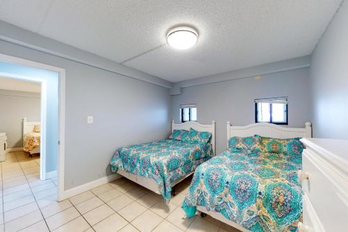 a bedroom with a bed and a bed and a window at Carousel 1904 in Ocean City