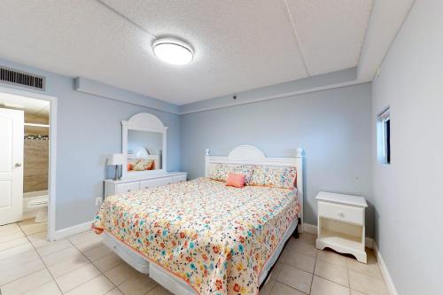 a blue bedroom with a bed and a mirror at Carousel 1904 in Ocean City