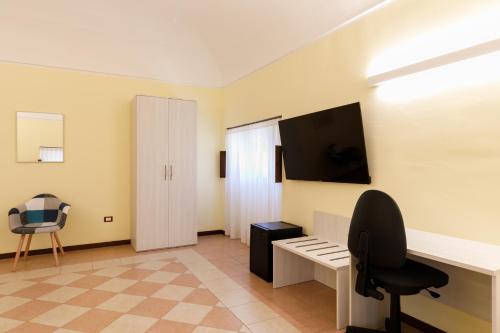 a room with a desk and a tv on the wall at B&B Lanciano in Lanciano