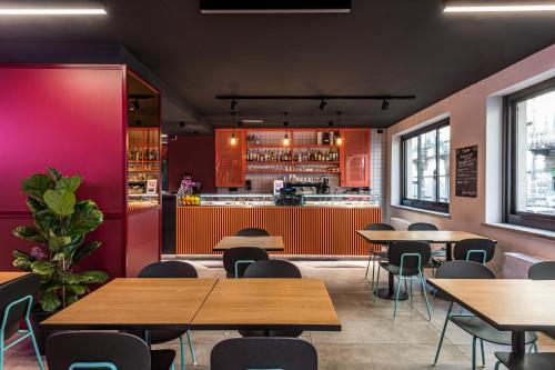 a restaurant with tables and chairs and a bar at CX Turin Marconi in Turin