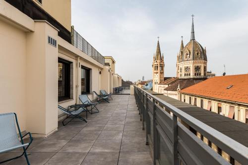 a balcony with chairs and a view of a city at CX Turin Marconi in Turin