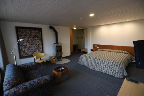 a hotel room with a bed and a couch at Hotel Andino Club - Hotel Asociado Casa Andina in Huaraz
