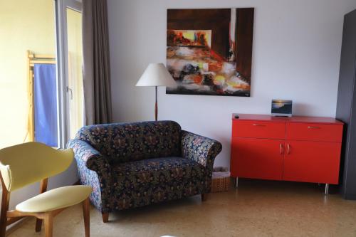 a living room with a chair and a red dresser at Hotel Andino Club - Hotel Asociado Casa Andina in Huaraz