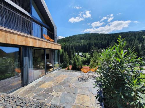 a patio with a table and chairs on a building at Panorama Lofts Pec in Pec pod Sněžkou