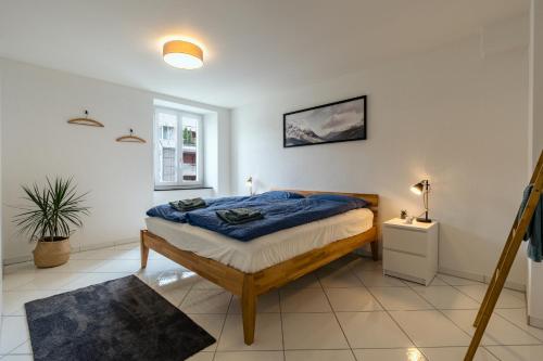 a bedroom with a bed with a blue comforter at Apartment in the city center with free parking in Biel