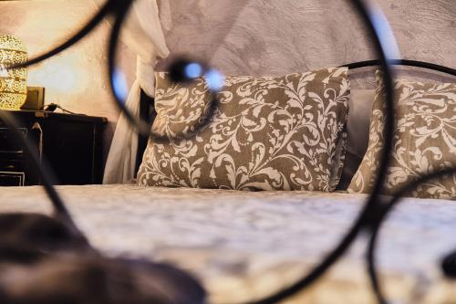 a bedroom with a bed with a pillow and a lamp at Riad Medina Mudéjar Cádiz in Chiclana de la Frontera