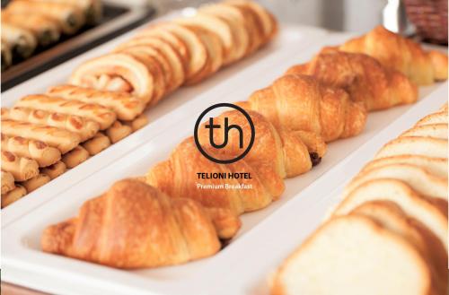 a tray of croissants and other pastries on display at Telioni Hotel in Thessaloniki