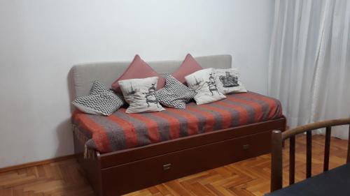a couch with pillows on it in a room at Departamento Cañada Patio Olmos in Córdoba