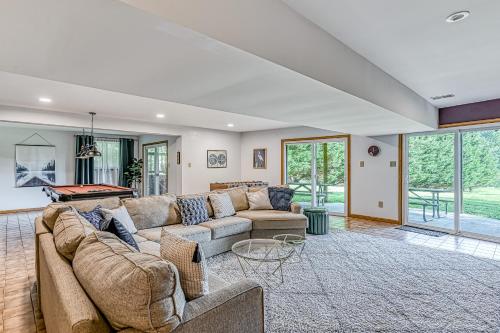 a living room with a couch and a pool table at The Blue Heron Retreat in Bumpass