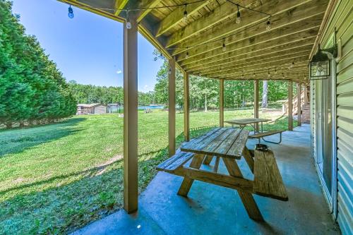 a picnic table on the porch of a house at The Blue Heron Retreat in Bumpass