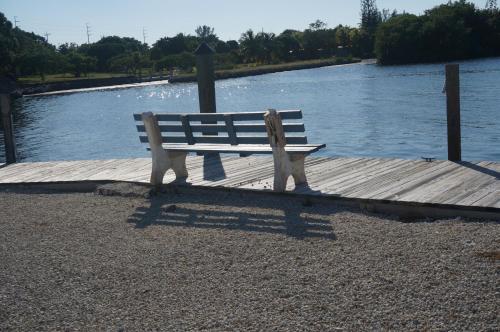 a park bench sitting on a dock next to the water at Florida Keys in Marathon