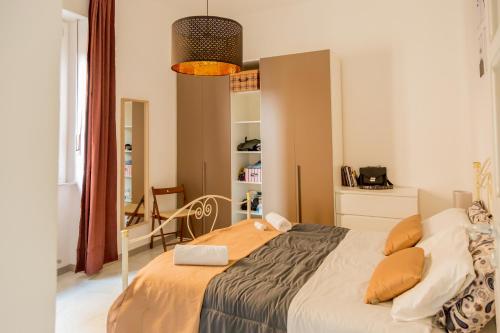 a bedroom with a bed and a chair in it at - CASA MANZONI - Luminoso appartamento zona Sferisterio in Macerata