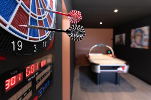 a dart board with a dart in a room with a table at Pomme de Reinette in Azay-le-Rideau