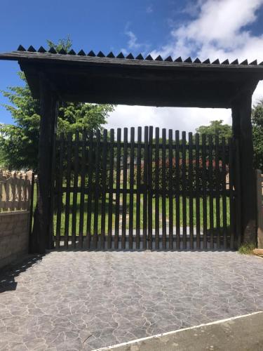 a black gate with a stone patio at Pensión Xacobe in Cabreiros