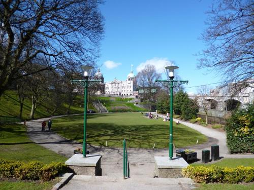 a park with two street lights in front of a building at Holiday Inn Express Aberdeen City Centre by IHG in Aberdeen