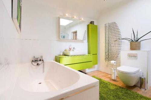 a bathroom with a sink and a toilet and a mirror at 6 bedrooms beautiful home 3 bathrooms, quiet location with garden near Legoland Windsor Heathrow in Maidenhead