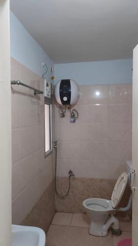 a small bathroom with a toilet and a shower at Hotel Aditya Palace in Rānchī